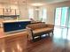 Open living space features laminate flooring, modern lighting, kitchen view and sliding glass door at 11143 Merganser Way, New Port Richey, FL 34654