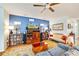 Comfortable living room with blue accent wall, wood entertainment center, and a cozy seating area at 11143 Merganser Way, New Port Richey, FL 34654