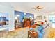 Inviting living room with blue accent wall, warm wood tones, plush seating, and lots of natural light at 11143 Merganser Way, New Port Richey, FL 34654