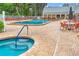 Resort-style pool and spa with orange chairs at 11143 Merganser Way, New Port Richey, FL 34654