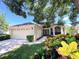 Charming single-story home with a well-manicured lawn, mature trees, and an attached two-car garage at 13626 Bryndlewood Ct, Hudson, FL 34669