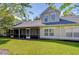Landscaped backyard with screened porch and grassy area at 3605 Kings Rd # 102, Palm Harbor, FL 34685
