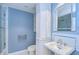 Charming blue bathroom featuring a mosaic tile backsplash, glass shower, and elegant fixtures for a refreshing experience at 3605 Kings Rd # 102, Palm Harbor, FL 34685