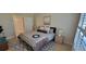 Bedroom with a neutral color scheme, patterned rug, and ample natural light at 3605 Kings Rd # 102, Palm Harbor, FL 34685
