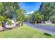 View of gated community entrance, lush landscaping, and stone signage features at 3605 Kings Rd # 102, Palm Harbor, FL 34685