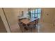 Bright dining area features a modern light fixture, stylish table and chairs, and elegant decor, perfect for entertaining at 3605 Kings Rd # 102, Palm Harbor, FL 34685