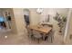 Bright dining area features a modern light fixture, stylish table and chairs, and elegant decor, perfect for entertaining at 3605 Kings Rd # 102, Palm Harbor, FL 34685