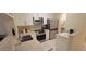 This kitchen features stainless steel appliances, granite countertops, and white cabinets at 3605 Kings Rd # 102, Palm Harbor, FL 34685