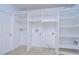 Bright laundry room features built-in shelving at 3605 Kings Rd # 102, Palm Harbor, FL 34685