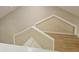 Upper level loft space featuring unique architectural details and hardwood floors at 3605 Kings Rd # 102, Palm Harbor, FL 34685