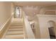Bright staircase leads to upper level, showcasing an architectural accent wall and design at 3605 Kings Rd # 102, Palm Harbor, FL 34685