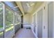 Bright screened-in porch with tile floor and ceiling fan at 3605 Kings Rd # 102, Palm Harbor, FL 34685