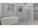 Bright bathroom featuring a soaking tub and a glass-enclosed shower with white subway tile at 3898 Southern Valley Loop, Brooksville, FL 34601