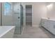 Bathroom featuring glass enclosed shower, soaking tub, and double vanity at 3898 Southern Valley Loop, Brooksville, FL 34601