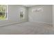 Light-filled bedroom with neutral carpeting and picturesque windows at 3898 Southern Valley Loop, Brooksville, FL 34601