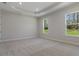 Large bedroom with carpeted floors and windows offering natural light and outdoor views at 3898 Southern Valley Loop, Brooksville, FL 34601