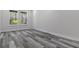 Empty bedroom featuring gray wood-look floors and large windows at 3898 Southern Valley Loop, Brooksville, FL 34601