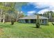 Exterior view of the backyard and patio with landscaping and natural light at 3898 Southern Valley Loop, Brooksville, FL 34601