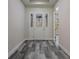 Foyer with decorative front door and gray wood flooring at 3898 Southern Valley Loop, Brooksville, FL 34601
