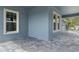 Covered front porch with brick flooring showing the entry door and exterior architecture at 3898 Southern Valley Loop, Brooksville, FL 34601