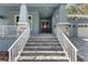 Inviting front entrance with a beautiful stone stairway, a decorative front door and a covered porch at 3898 Southern Valley Loop, Brooksville, FL 34601