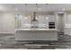 A spacious kitchen boasting a large center island with a sink, pendant lighting, and ample countertop space at 3898 Southern Valley Loop, Brooksville, FL 34601