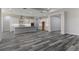 Spacious open-concept kitchen with white cabinets, stainless steel appliances and island at 3898 Southern Valley Loop, Brooksville, FL 34601