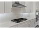 Close up of the kitchen featuring white cabinets, countertops and stainless steel appliances, with subway tile backsplash at 3898 Southern Valley Loop, Brooksville, FL 34601