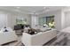 Staged living room featuring white furniture and gray wood floors at 3898 Southern Valley Loop, Brooksville, FL 34601