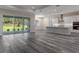 Open living space with a kitchen and sliding glass doors to the outdoor area at 3898 Southern Valley Loop, Brooksville, FL 34601