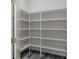 Spacious pantry with gray floors and white wood shelving for optimal storage at 3898 Southern Valley Loop, Brooksville, FL 34601