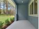 Covered patio with gray concrete floor and an open view to the lush green yard at 3898 Southern Valley Loop, Brooksville, FL 34601