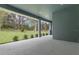 Covered patio with view to the landscaped green backyard at 3898 Southern Valley Loop, Brooksville, FL 34601