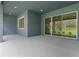 Spacious outdoor patio featuring recessed lights and sliding glass doors to the backyard at 3898 Southern Valley Loop, Brooksville, FL 34601