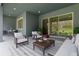 Covered patio with comfortable seating and view of the landscaped backyard at 3898 Southern Valley Loop, Brooksville, FL 34601