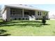 Expansive backyard featuring well-maintained lawn, covered patio and lush landscaping at 4676 Hickory Oak Dr, Brooksville, FL 34601