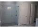 Modern bathroom with walk-in shower featuring sleek gray subway tile and frameless glass door at 4676 Hickory Oak Dr, Brooksville, FL 34601