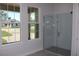 Modern bathroom featuring a frameless glass shower with white subway tile and views to the outside at 4676 Hickory Oak Dr, Brooksville, FL 34601
