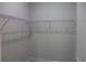 Walk-in closet featuring ample wire shelving, neutral walls and plush carpet at 4676 Hickory Oak Dr, Brooksville, FL 34601