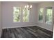 Dining room filled with natural light from many windows, chandelier and hard surface flooring at 4676 Hickory Oak Dr, Brooksville, FL 34601