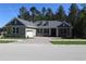 Charming home with a paved driveway, attached garage, manicured lawn and a traditional architectural style at 4676 Hickory Oak Dr, Brooksville, FL 34601