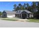 Charming home with a paved driveway, attached garage, manicured lawn and a traditional architectural style at 4676 Hickory Oak Dr, Brooksville, FL 34601
