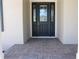 Elegant front entrance with stylish door, transom windows, and charming brick walkway at 4676 Hickory Oak Dr, Brooksville, FL 34601
