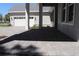 Covered front porch with brick pavers and elegant columns leading to attached two car garage at 4676 Hickory Oak Dr, Brooksville, FL 34601