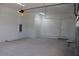Spacious two car garage with white walls, overhead lighting, and utility door to interior of home at 4676 Hickory Oak Dr, Brooksville, FL 34601