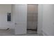 Interior garage door leading to shelved storage space with electrical panel and concrete flooring at 4676 Hickory Oak Dr, Brooksville, FL 34601