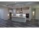 Bright, modern kitchen with white cabinets, center island, and stainless steel appliances at 4676 Hickory Oak Dr, Brooksville, FL 34601