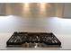 Close-up of gas range cooktop with white quartz counters and subway tile backsplash at 4676 Hickory Oak Dr, Brooksville, FL 34601