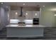 Modern kitchen featuring a large island with quartz countertops, stainless steel appliances, and pendant lighting at 4676 Hickory Oak Dr, Brooksville, FL 34601