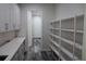 Spacious pantry featuring ample shelving and modern white cabinets with sleek hardware and durable quartz countertops at 4676 Hickory Oak Dr, Brooksville, FL 34601